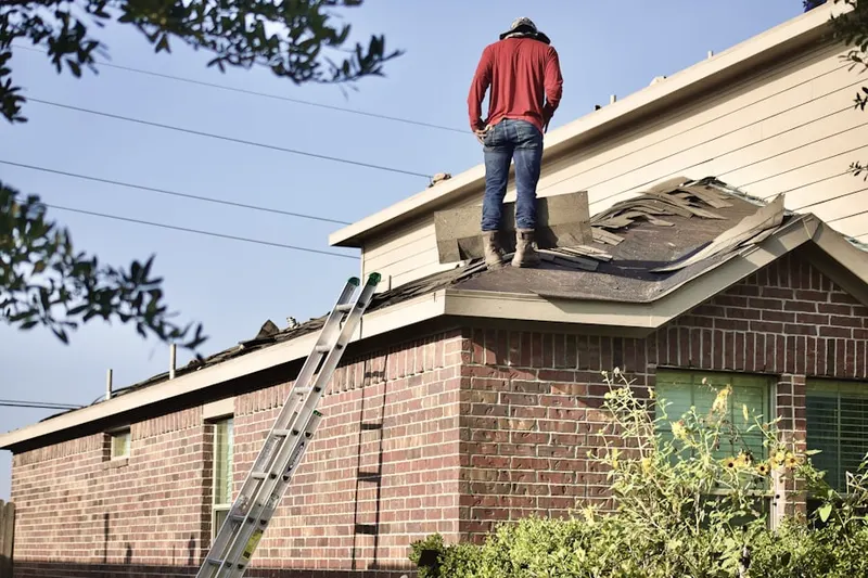Professional roofer working on a residential roof in A Country Place